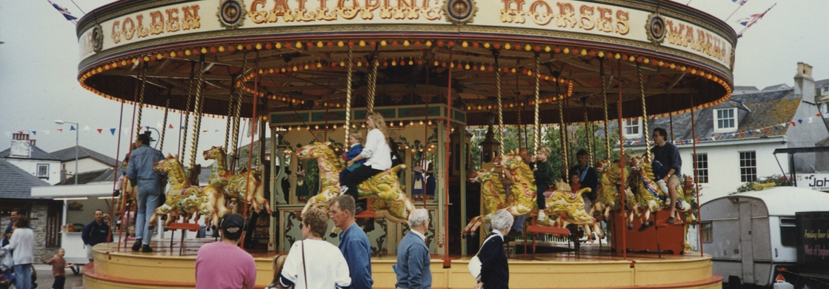 Fairground carousel and riders on the Town Square, Kingsbridge