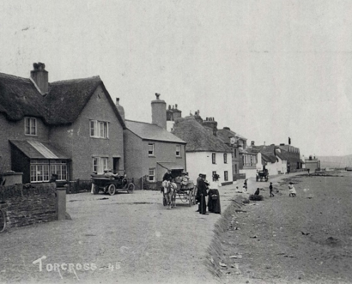The sea front at Torcross looking north, early motor car and two carts on the beachfront road